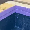 “Close-up of kicker block sealed with liquid damp proof membrane paint.”