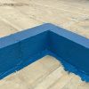 “Protective waterproof DPM liquid paint forming barrier on kicker block.”
