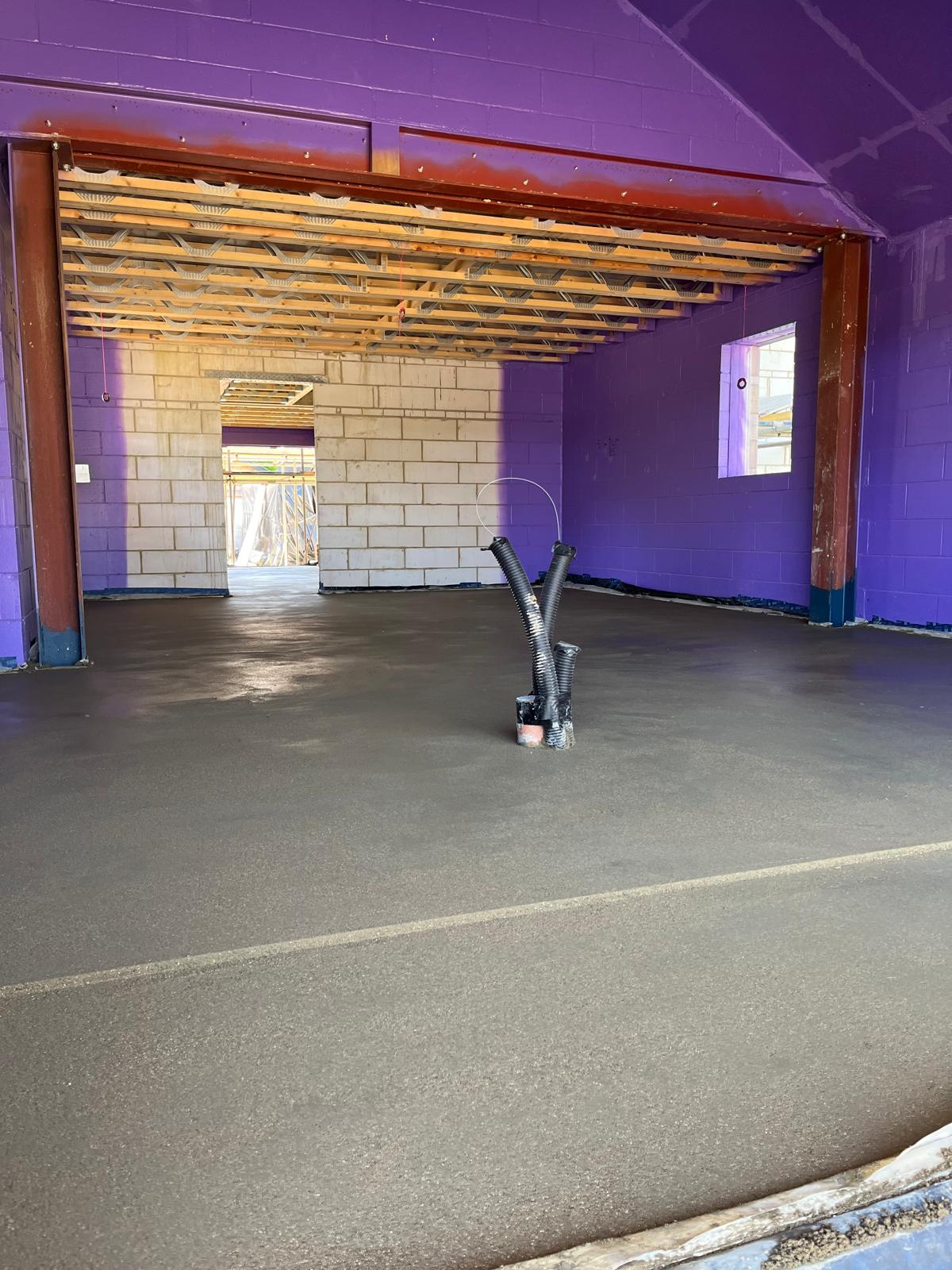 Close-up of Passive Purple liquid-applied vapour control layer being installed on The Dairy build to meet Passive House airtightness standards