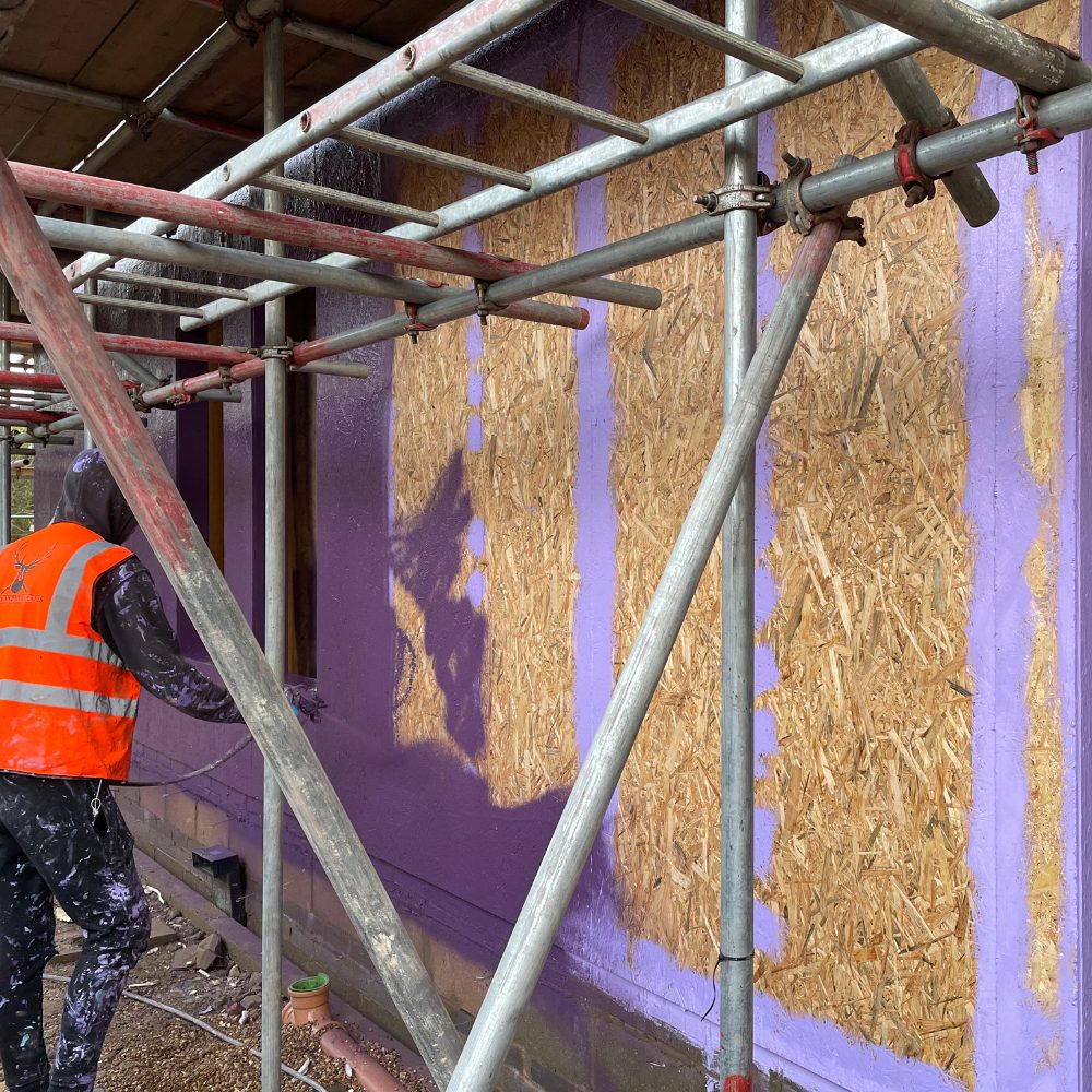 Applying Passive Purple External Class B fire-rated membrane to external walls for improved building safety and airtightness