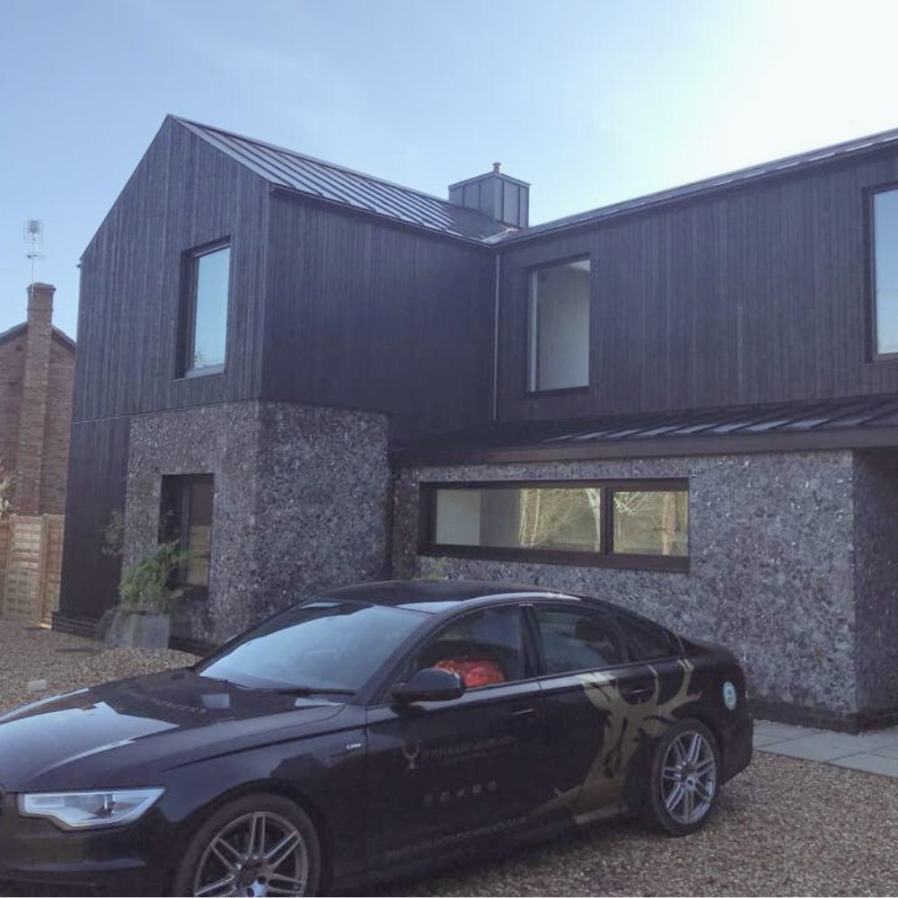 Passive Purple External membrane being sprayed onto Passive House façade to achieve airtightness and weatherproofing standards