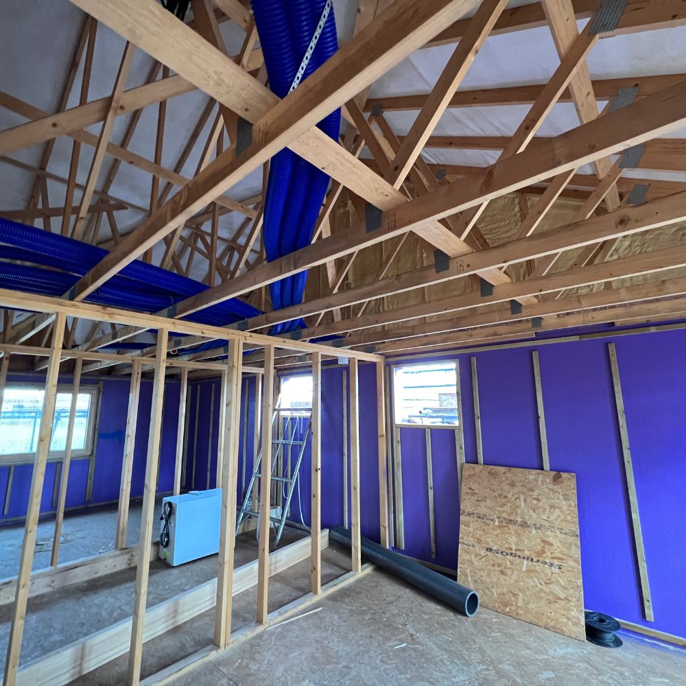 High-performance Passive Purple coating on timber frame structure, ensuring exceptional airtightness and energy efficiency.